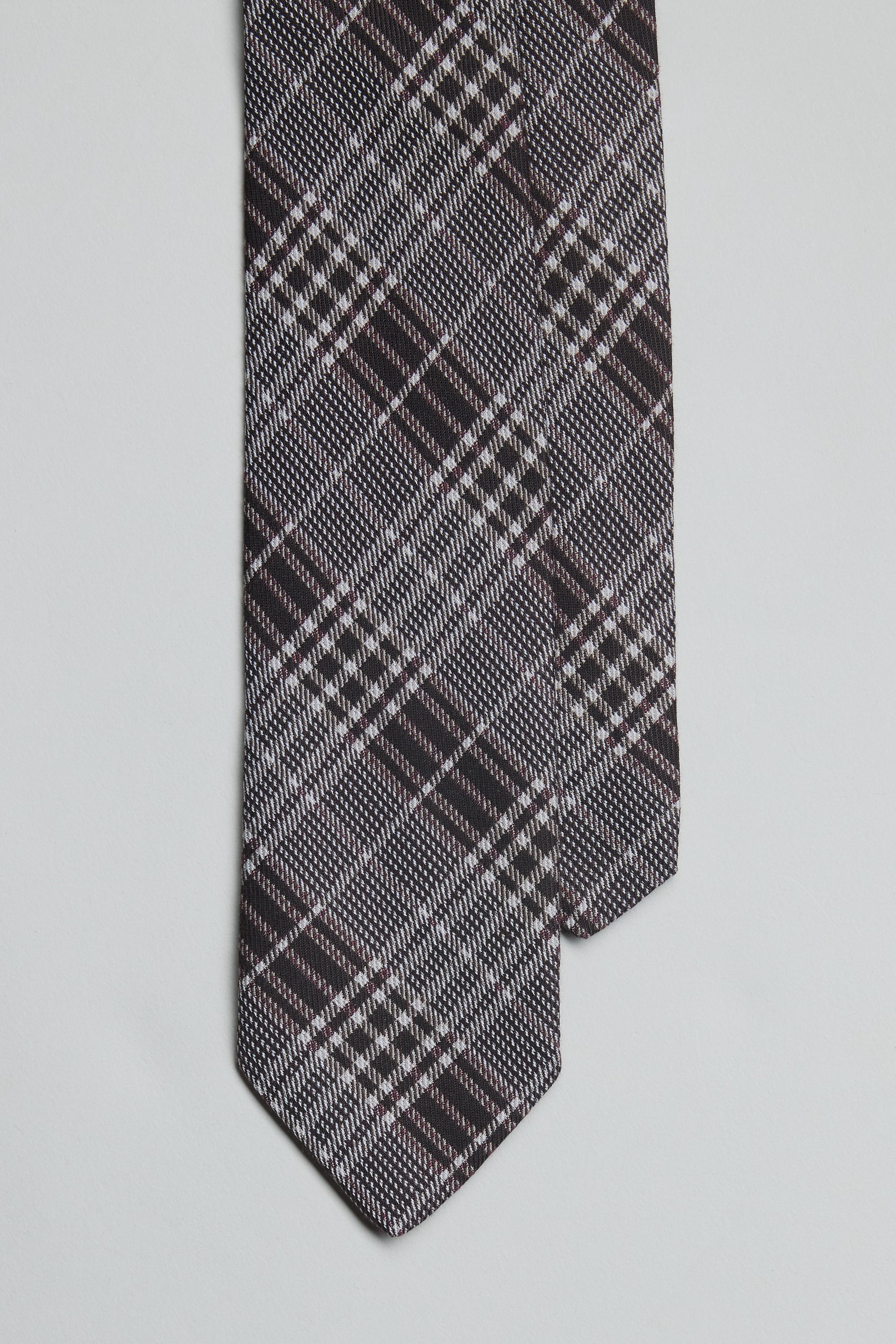 A close-up of two overlapping Parisian Hutton Check Ties by Parisian, handmade in New Zealand with a black, white, and burgundy plaid pattern, displayed on a plain white background.