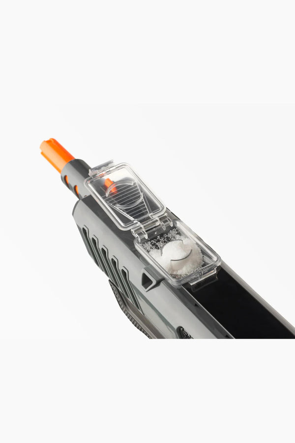 Close-up of the Bug-A-Salt 3.0 Black Fly by Other features a gray insect eradication device with an orange tip and an open clear compartment holding round white pellets—perfect for efficient fly elimination.