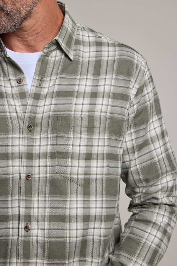 A close-up shows a person wearing a green check Barkers Paxtonheck Shirt over a white T-shirt, with only the lower face, neck, and upper torso visible.