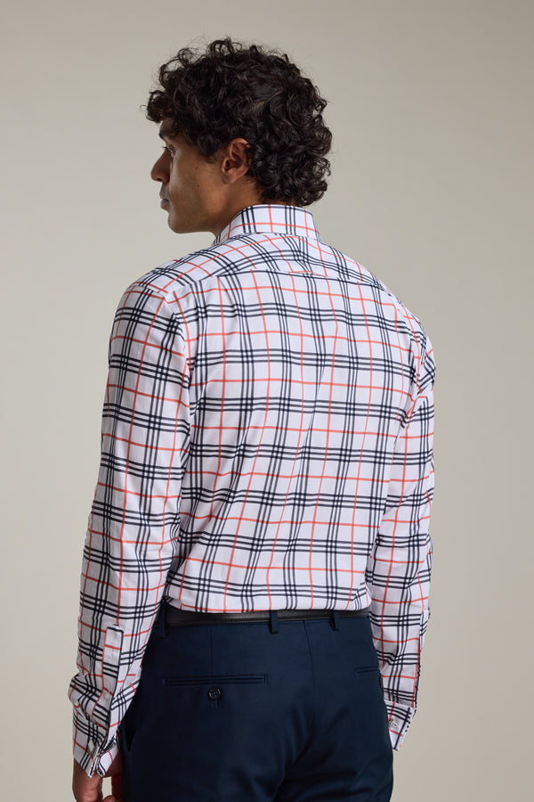 A man with curly hair, seen from behind, wears the Barkers Wilma French Cuff Business Shirt in a tailored white fabric with red and black plaid, paired with dark navy trousers against a plain light background.