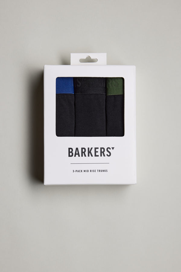 A white box with a clear window displays three pairs of Barkers 3-Pack Organic Trunk in black, blue, and green. The Barkers brand name is shown on the box against a plain light background.
