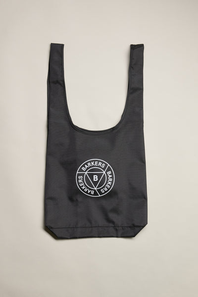 The Barkers Shopping Bag is a black recycled polyester tote with wide handles and a white circular Barkers logo in the center, shown flat on a light background.