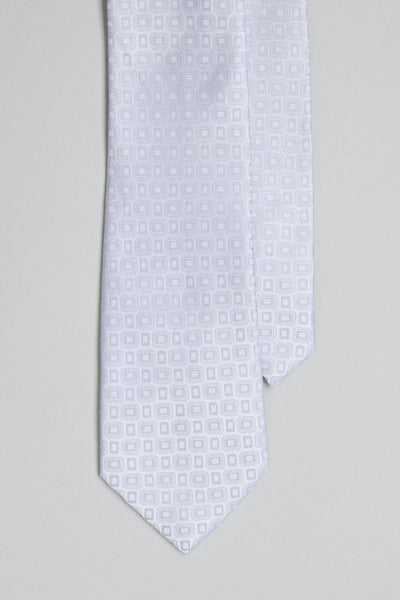 A close-up of the Barkers Royale Texture Tie in white, showcasing a subtle geometric jacquard pattern against a light gray background—an elegant option for business wear.
