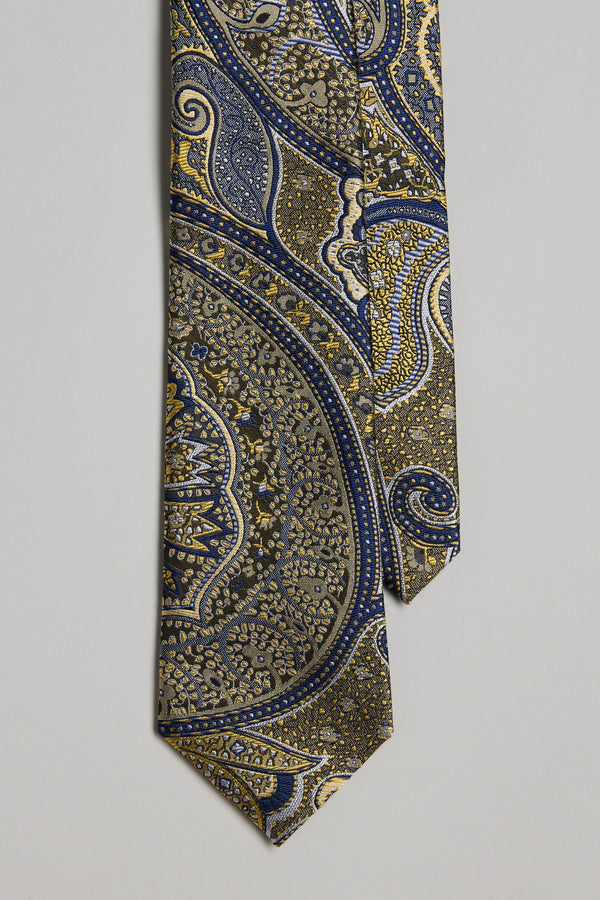 The Shubert Paisley Tie by Barkers showcases an intricate paisley pattern in gold, blue, and navy on a neutral silk background—ideal for pairing with Barkers silk bow ties and pocket squares at formal events.