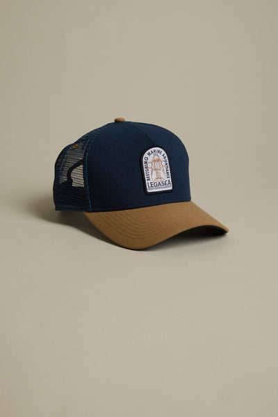 The Legasea Crayfish Trucker Snapback Cap features a navy front and bill, brown brim, black mesh back, and a rectangular crayfish patch logo. Classic trucker snapback style from Legasea with a standout two-tone design.