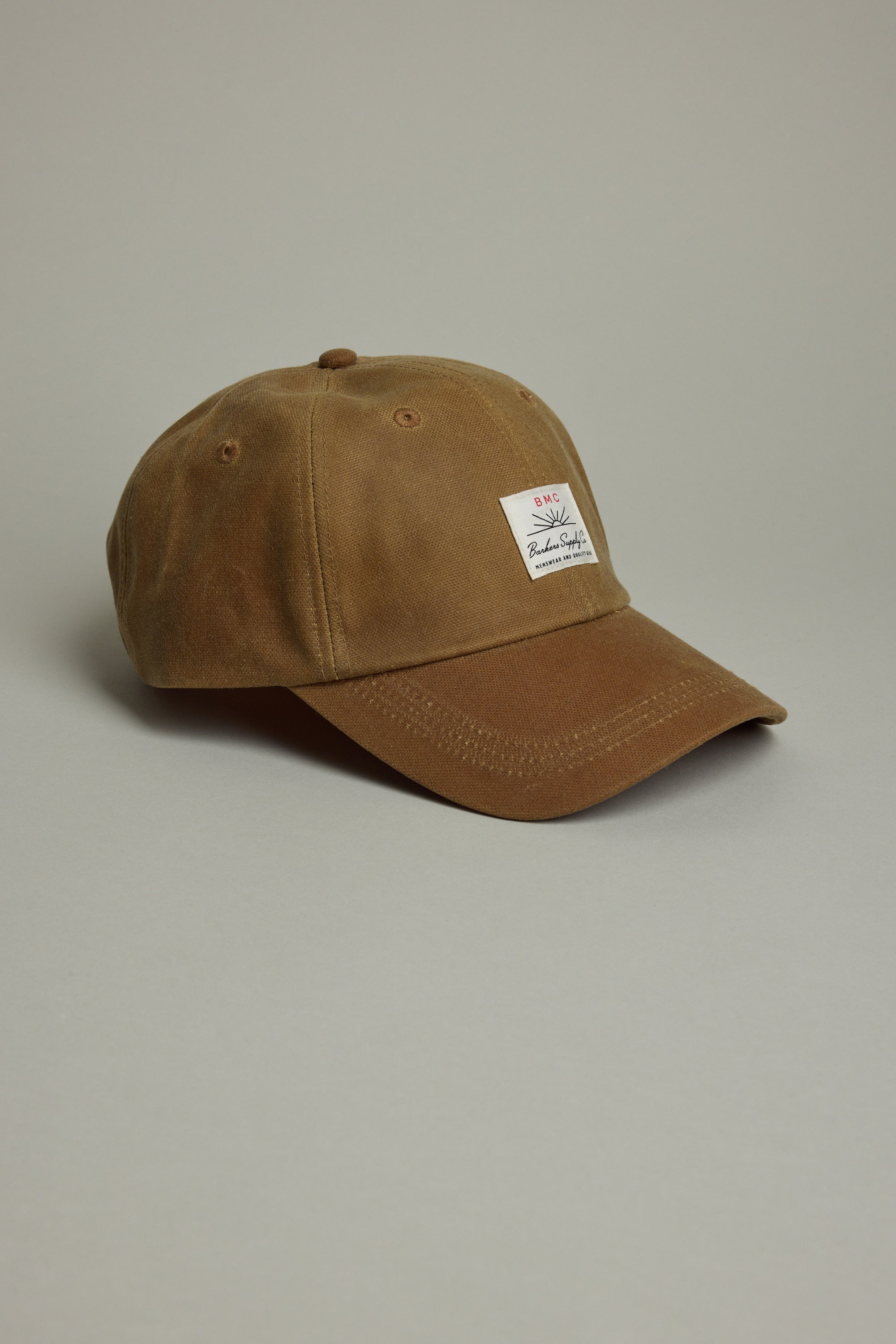 Barkers Benson Waxed Cotton Cap—brown, adjustable fit, white patch, on gray background.