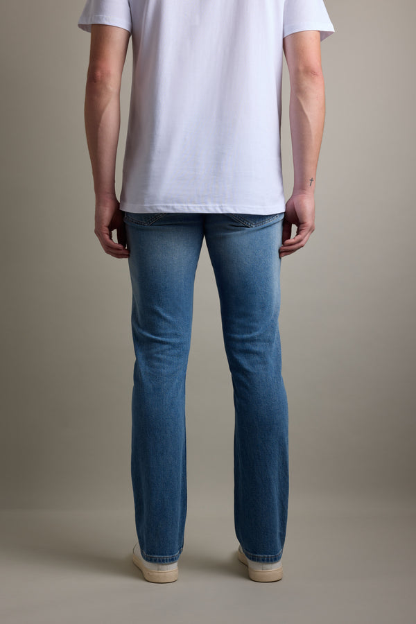 Person standing, facing away, in a white t-shirt and Barkers Wanderer Denim Straight Jeans.
