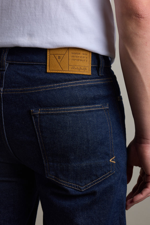 Person in Barkers Drifter Denim Relax Jean, displaying the back pocket and leather label.