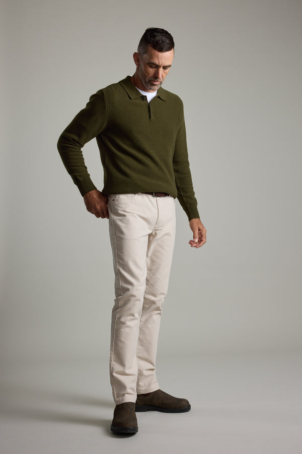 Man wears Barkers Ainsley Woollen Long Sleeve Polo with beige pants and brown boots.