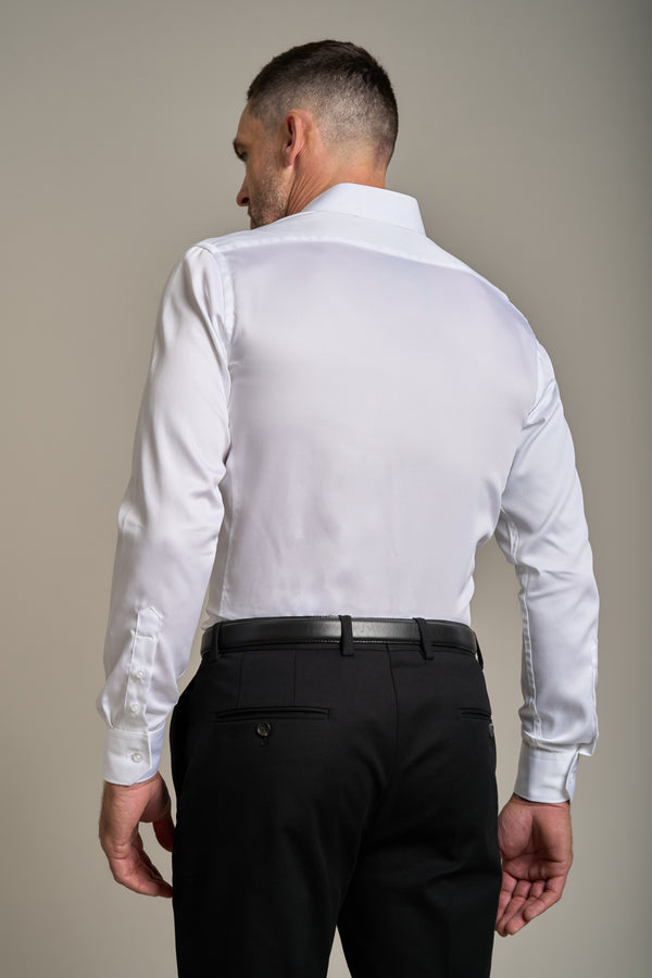 A man stands with his back to the camera, wearing the Barkers Tribeca Reg Cuff Shirt tucked into black dress pants with a black belt, against a plain neutral background.