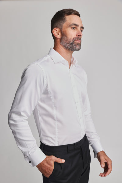 A man with short dark hair and a beard wears the Barkers Tribeca French Cuff Shirt and black trousers, standing with one hand in his pocket and looking to the side against a plain light background.