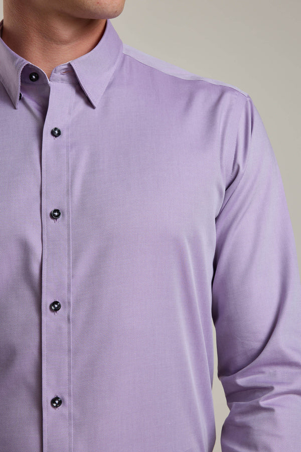 A person wears the Barkers Verona Shirt, a tailored fit, light purple long sleeve business shirt with dark buttons, classic collar, and 100% cotton fabric. The image displays the upper torso and part of the neck.