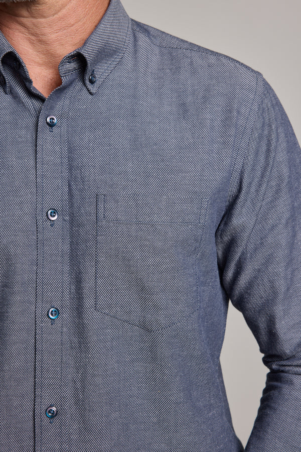 A close-up of a person wearing the Barkers Tyson Texture Shirt, a light blue tailored fit with a chest pocket. Only the upper torso and part of the left shoulder are visible; the face is partially out of frame.