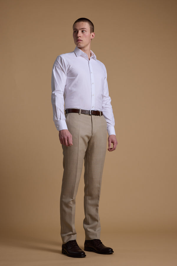 Man in Barkers Aster Texture Business Shirt, beige pants, brown shoes on tan background.