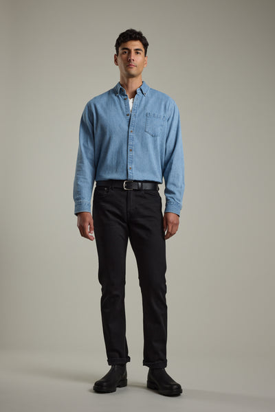 Man in a Barkers Avalon Denim Shirt, black jeans, and boots against a plain background.