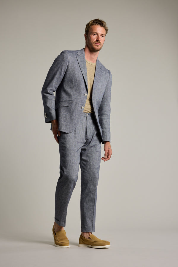 Man in Barkers Paden Twill Pant, beige shirt, and tan shoes against a plain background.