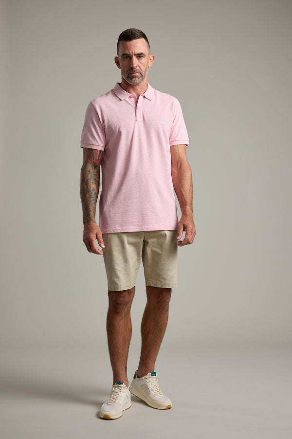 Man in Barkers Regent Pique Polo, beige shorts, and sneakers.