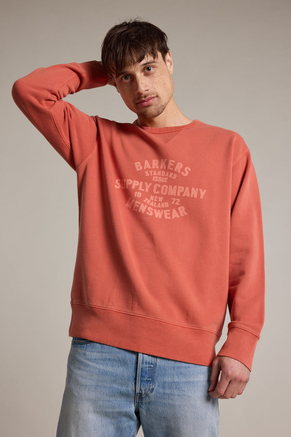 A man posing for a picture in the Barkers Standard Issue Print Crew, made from loop back fleece.