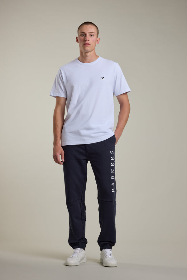 Man in white tee and Barkers Organic Classic Print Track Pant stands against a plain background.