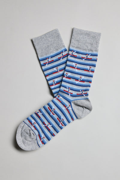 A pair of Barkers Ronnie Rower Socks in gray, featuring blue and gray stripes with small red and white boat patterns, laid flat on a light gray background—comfortable and ideal for everyday wear.