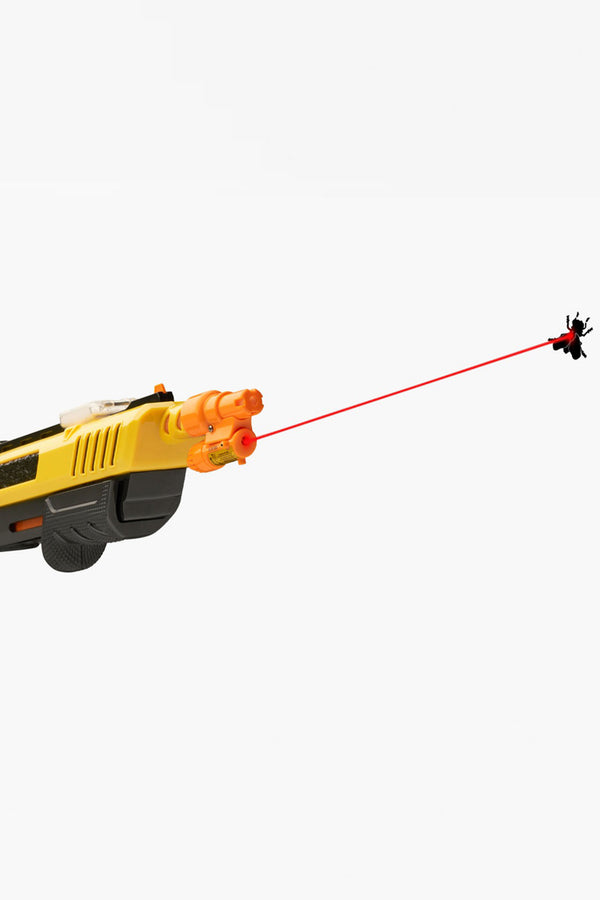 The Barkers Bug-A-Salt Laser Beam, a yellow and black fly killer toy gun with an orange tip and red laser for accuracy, targets a flying insect against a plain white background.