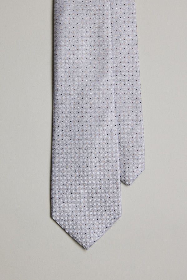 The Barkers Nilson Dot Tie, crafted from fine silk, features a light gray color with a small repeating geometric dot pattern, shown up close against a plain light background.