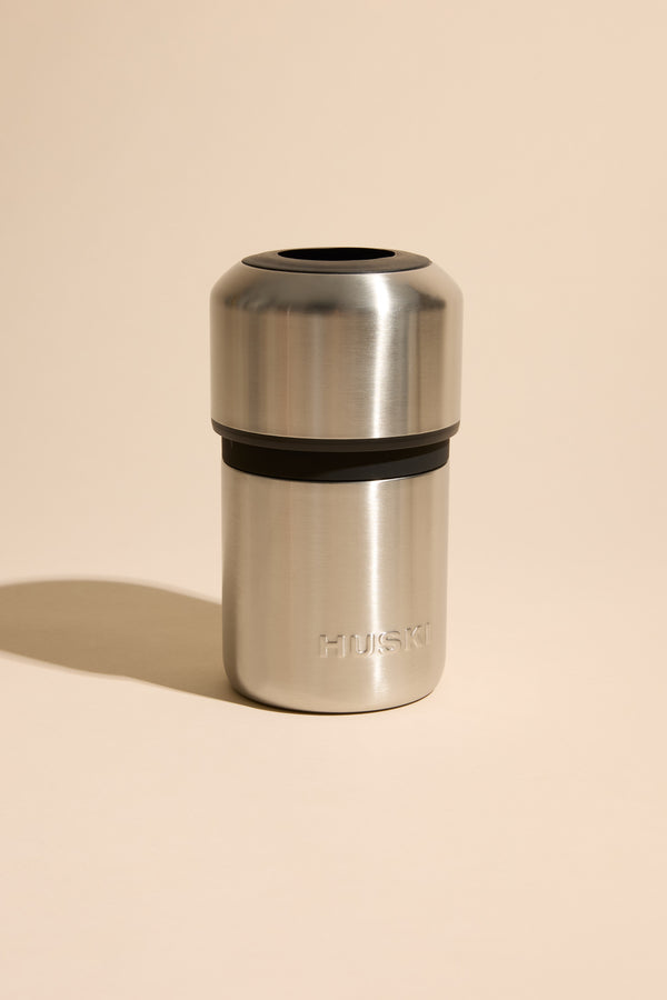 The Huski Wine Cooler by Huski is a stainless steel insulated drink tumbler with a black band and "HUSKI" embossed near the bottom—perfect for keeping your wine cold.