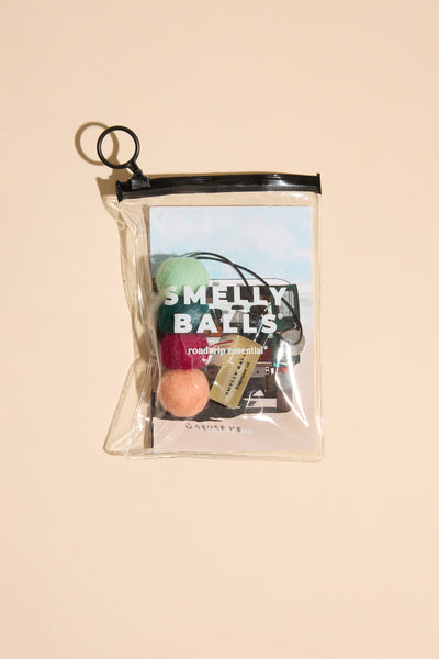 Other's Smelly Balls: Roadie / Tobacco Vanilla set features four colorful balls, a Tobacco Vanilla fragrance vial, and a car-illustrated card in a clear zippered pouch, shown against a beige background.
