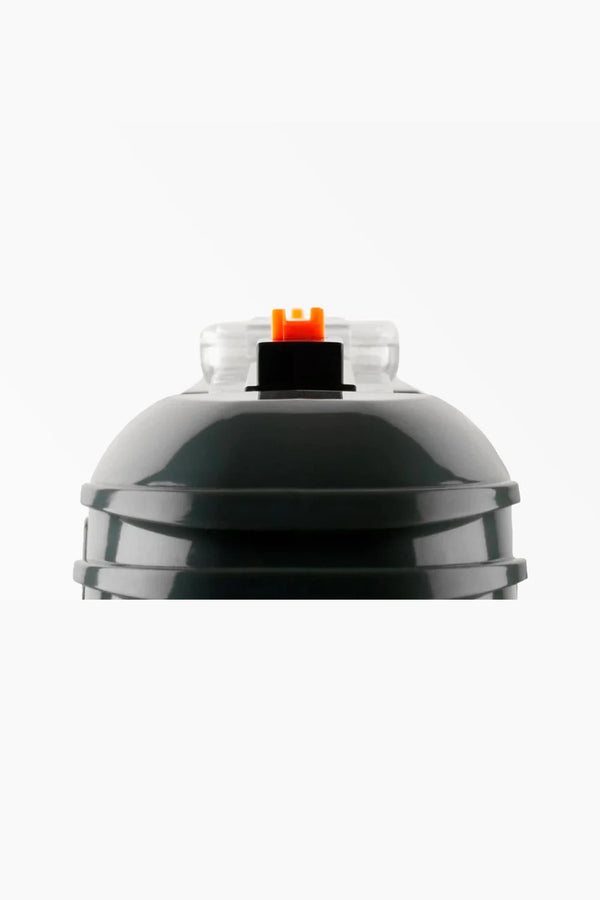 Close-up of the top of the Bug-A-Salt 3.0 Black Fly by Other, a black cylindrical insect eradication device with a transparent cap and orange-black button, designed for effective fly elimination, shown on a white background.