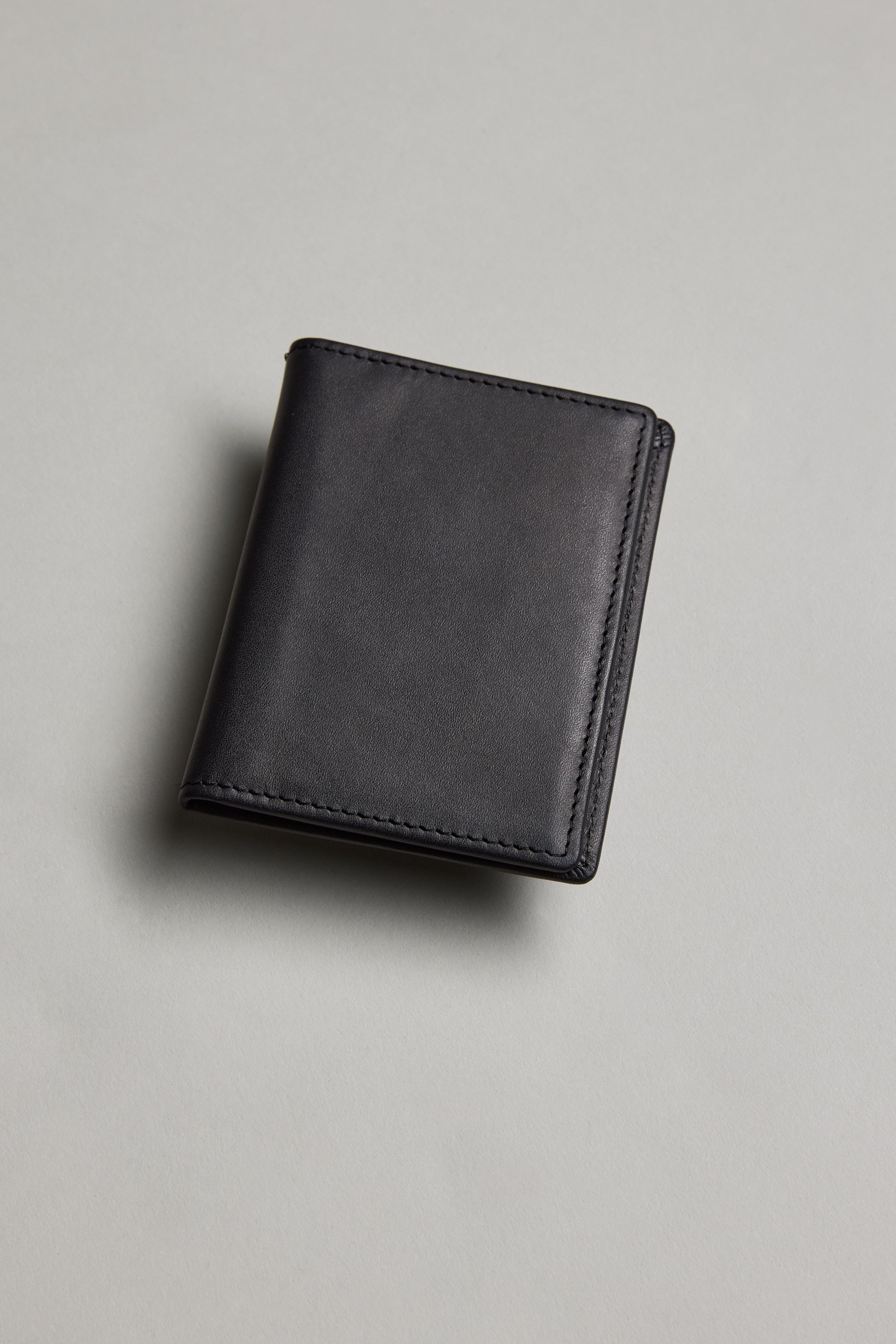 A closed Marlin Leather Slim Wallet by Barkers rests on a light grey surface, shown from above.