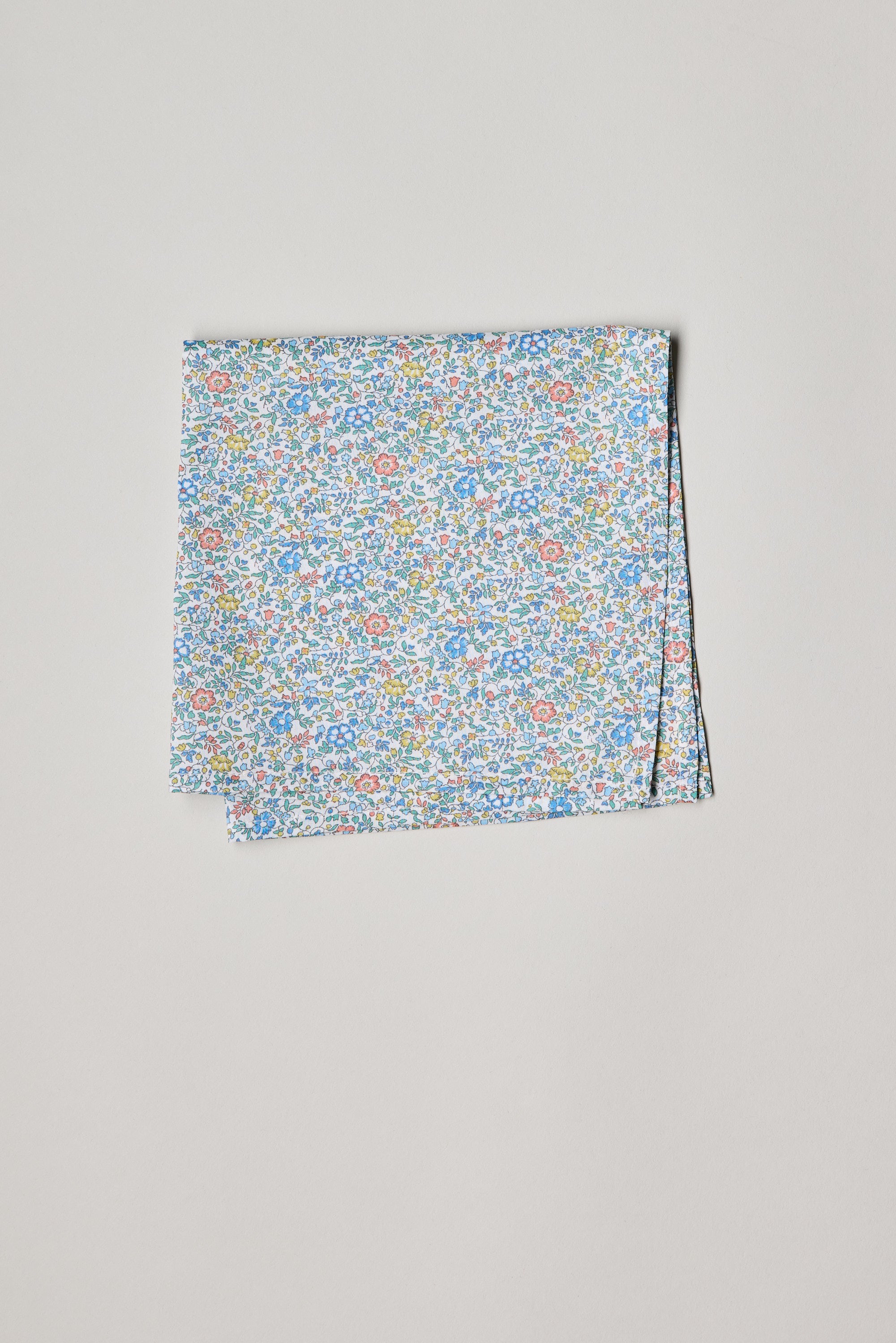 Liberty's Katie and Millie pocket square in blue, red, and green floral print on white cotton.