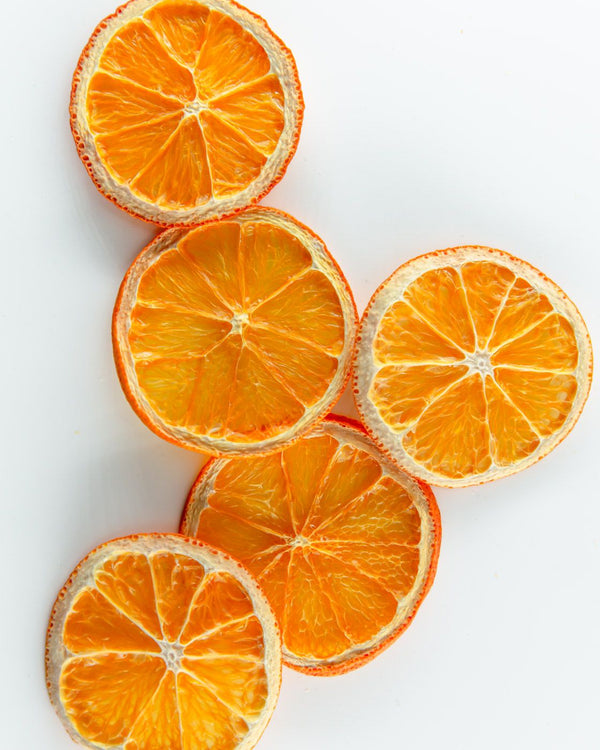 F N Lemons - Oranges 6 Slice Pouch by F N Lemons features six vibrant dried orange slices on a white background, highlighting their textured edges—an ideal premium garnish for cocktails or baking.