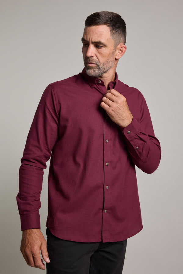A man with short dark hair and a trimmed beard wears the Barkers Antonio Shirt, adjusting his collar while looking to his left against a plain light background.