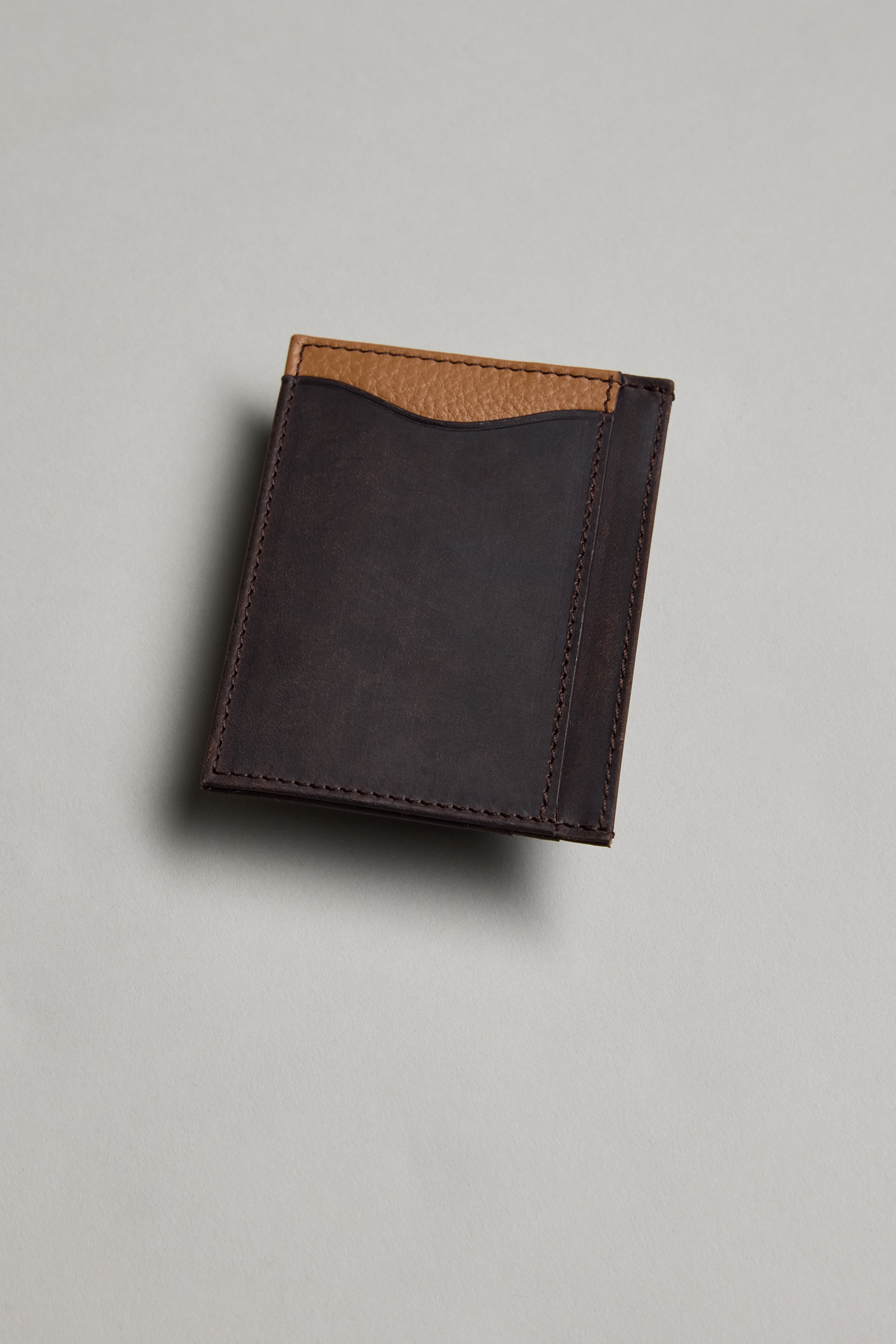 The Barkers Taylor Leather Card Wallet, a closed slim card holder in brown leather with a tan accent on the top edge, is shown photographed on a light gray surface.