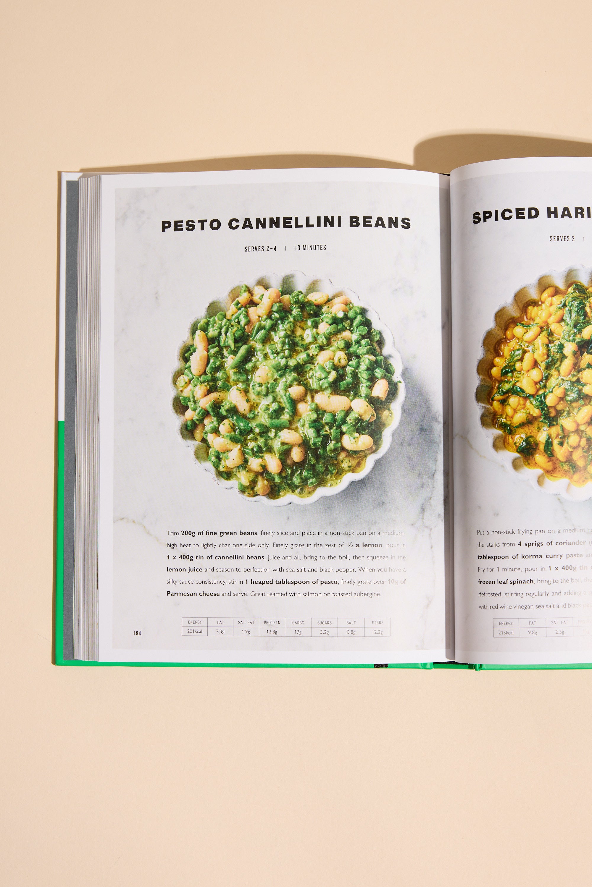 An open Simply Jamie cookbook by Other displays a pesto cannellini beans recipe—white beans and green pesto—in a round dish on a light background. Ideal for quick midweek meals, with another recipe partially visible on the right page.