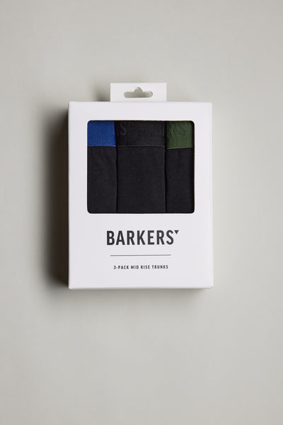 A white box with a clear window displays three pairs of Barkers 3-Pack Organic Trunk in black, blue, and green. The Barkers brand name is shown on the box against a plain light background.