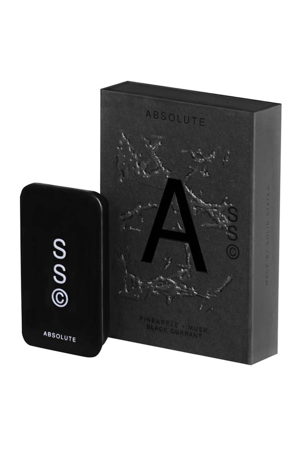 A black rectangular Solid State - Icon cologne bottle stands beside a matching box labeled with a bold A and notes of PINEAPPLE • MUSK • BLACK CURRANT, reflecting modern Australian-inspired fragrances.