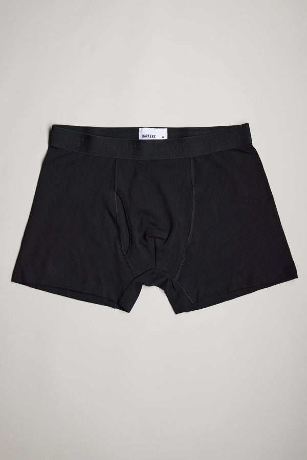 A trio of Barkers 3-Pack Organic Trunks in plain black rests on a light gray surface, showcasing breathable comfort and modern style in men's underwear.