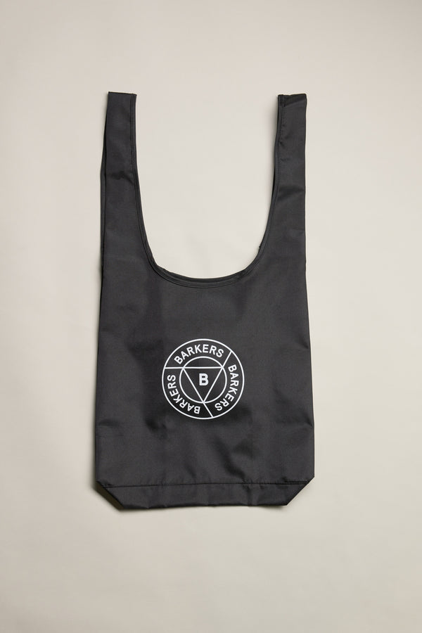 The Barkers Shopping Bag is a black recycled polyester tote with wide handles and a white circular Barkers logo in the center, shown flat on a light background.