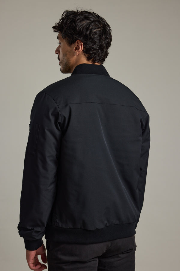 A man in a Barkers Dunhill Bomber Jacket, shown from the back against a plain background.