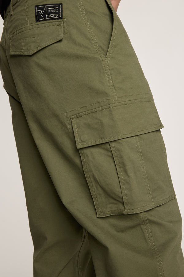 A close-up of the Barkers Barnard Cargo Pant, showcasing its relaxed fit twill cotton design, large side pockets, and a black patch above the back pocket with emphasis on detailed stitching.
