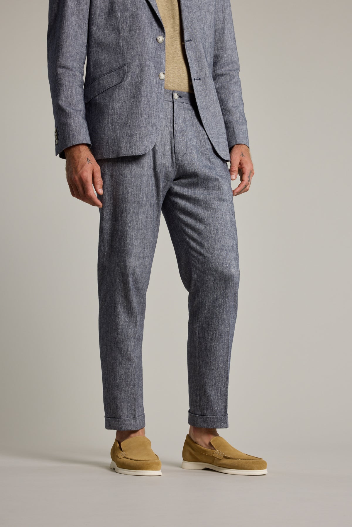Man in Paden Twill Pant by Barkers, beige shirt, tan loafers, on a plain background.