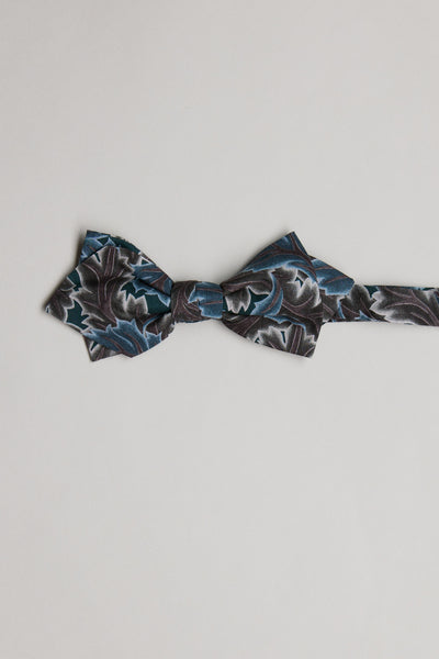 The Liberty Midnight Canopy Bow Tie by Liberty is handmade in New Zealand from premium Tana Lawn cotton and showcases dark blue, black, and gray patterns on a light background.