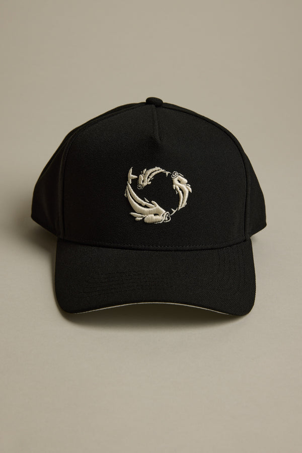 The Legasea Logo Snapback Cap by Legasea is a black adjustable hat featuring an embroidered design of three koi fish swimming in a circular pattern on the front, shown against a neutral background.
