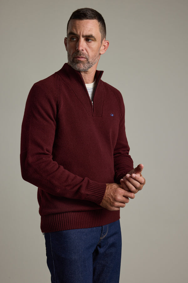 Man in Barkers Rowley Woollen 1/4 Zip sweater and blue jeans, against a plain background.