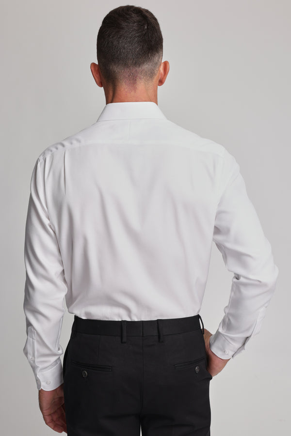 A man stands with his back to the camera, wearing the Barkers Mexted Texture Shirt in white and black dress pants, set against a plain light background.