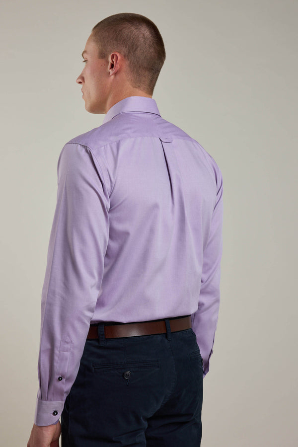 A person stands with their back to the camera, wearing the Barkers Verona Shirt—a light purple, tailored-fit business shirt—paired with dark pants and a brown belt against a plain, light-colored background.