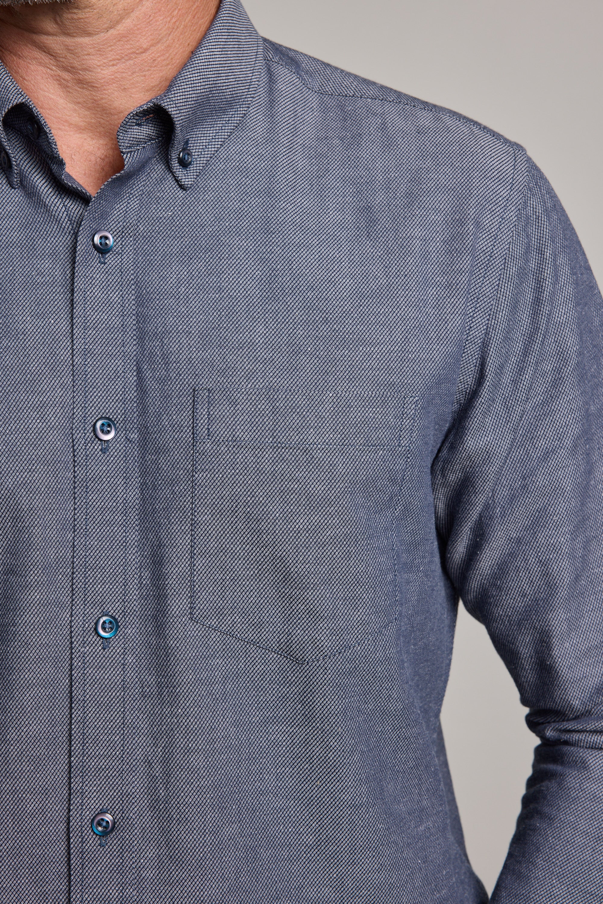A close-up of a person wearing the Barkers Tyson Texture Shirt, a light blue tailored fit with a chest pocket. Only the upper torso and part of the left shoulder are visible; the face is partially out of frame.
