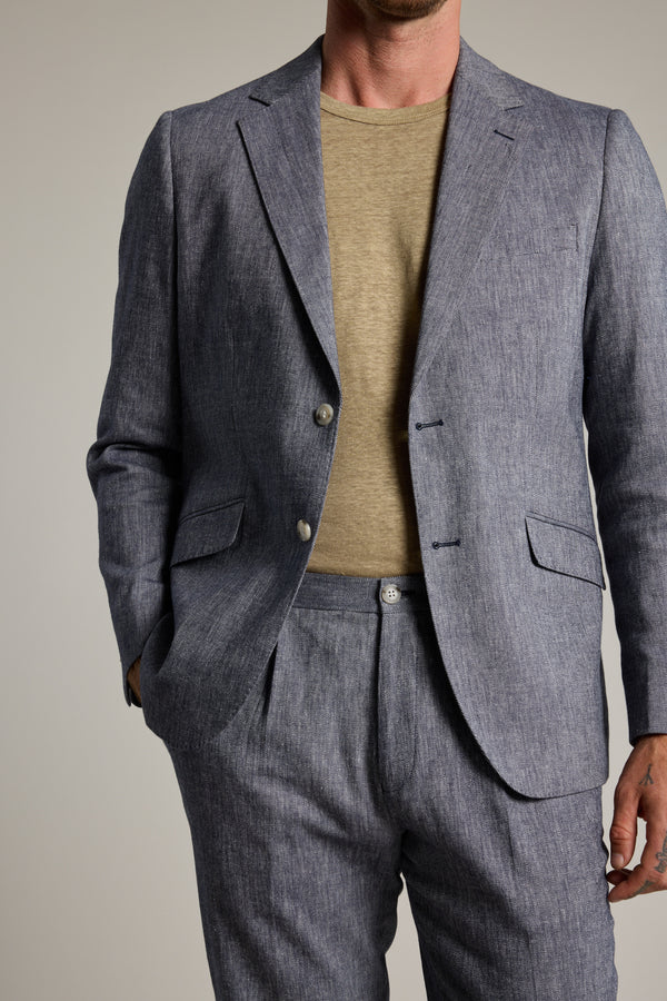 Man in Barkers Paden Twill Pant, beige tee, hand in pocket, cropped at neck.