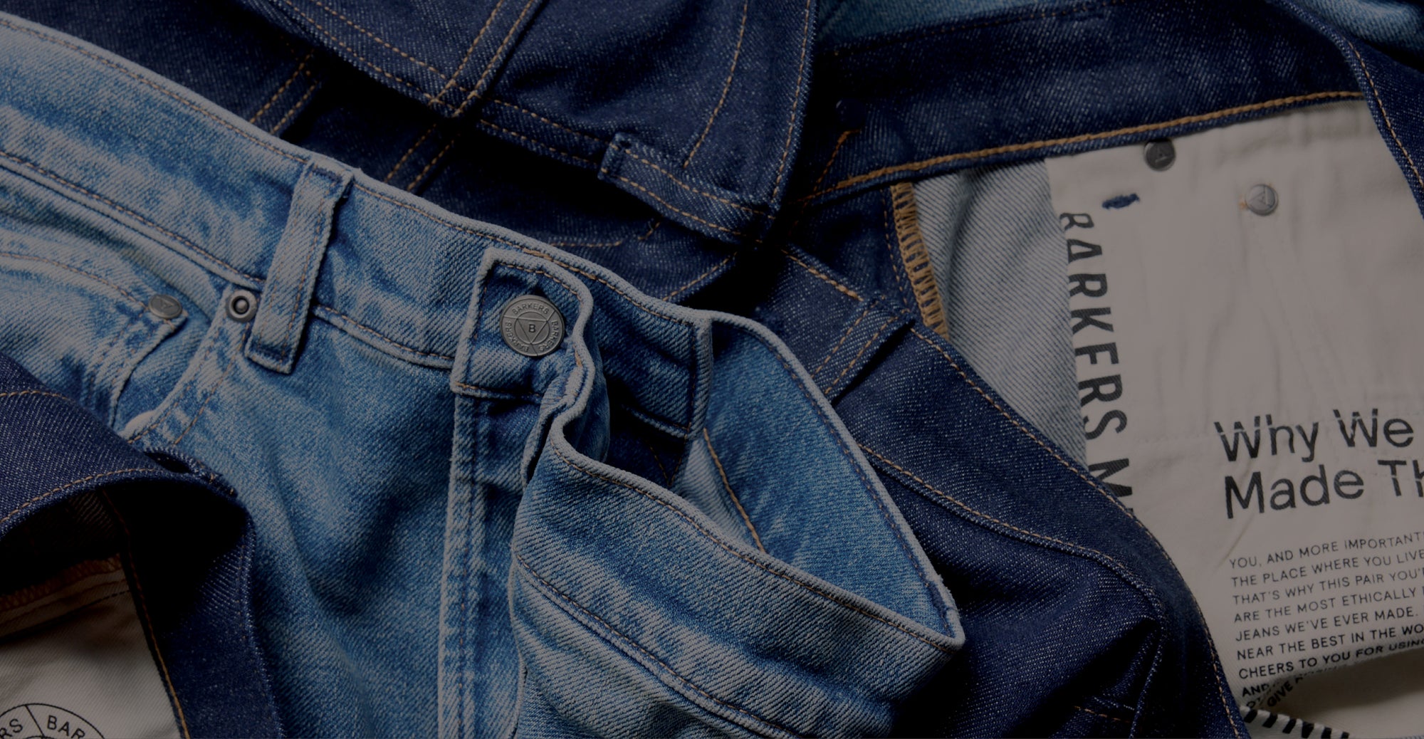 Close-up of blue denim jeans with NZ label and visible stitching inside the waistband.